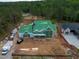 Aerial perspective of a newly constructed home showcasing its expansive layout and green roofing at 4812 Parker Meadow Dr, Raleigh, NC 27614