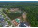 An aerial view showcasing multiple homes under construction within a densely wooded community at 4812 Parker Meadow Dr, Raleigh, NC 27614