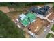 New construction home with modern design, surrounded by a lush green forest, showcasing a prime location at 4812 Parker Meadow Dr, Raleigh, NC 27614