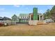 Spacious backyard view of a new home featuring large windows and a covered patio at 4812 Parker Meadow Dr, Raleigh, NC 27614