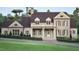A classic brick two-story home featuring a covered entrance, symmetrical windows, and lush landscaping at 4812 Parker Meadow Dr, Raleigh, NC 27614