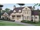 A classic brick two-story home featuring a covered entrance, symmetrical windows, and lush landscaping at 4812 Parker Meadow Dr, Raleigh, NC 27614