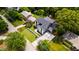Stunning aerial view of a modern home with a well-manicured lawn and a long driveway leading to a private garage at 5208 Knollwood Rd, Raleigh, NC 27609