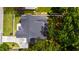 Overhead view of a well-maintained roof with an adjacent driveway, surrounded by lush trees and green lawns at 5208 Knollwood Rd, Raleigh, NC 27609