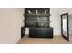 Stylish bar area with sleek black cabinetry, shelving, modern fixtures, and a contemporary design at 5208 Knollwood Rd, Raleigh, NC 27609
