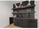 Contemporary bar area featuring sleek cabinetry, open shelving, and elegant lighting at 5208 Knollwood Rd, Raleigh, NC 27609