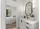 Stylish bathroom with modern mirror, and marble countertop with view into a cozy bedroom at 5208 Knollwood Rd, Raleigh, NC 27609