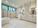 Modern bathroom features a soaking tub, walk-in shower, and a dual sink vanity with gold fixtures at 5208 Knollwood Rd, Raleigh, NC 27609