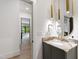 Chic bathroom featuring a marble countertop, and stylish gold fixtures at 5208 Knollwood Rd, Raleigh, NC 27609