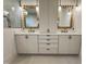 Beautiful bathroom vanity with double sinks, gold hardware, stylish mirrors, and elegant pendant lighting at 5208 Knollwood Rd, Raleigh, NC 27609