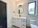 Bright bathroom features a modern vanity with marble countertops and stylish black fixtures at 5208 Knollwood Rd, Raleigh, NC 27609