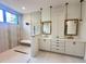 Modern bathroom features a glass shower, double vanity with framed mirrors, and stylish fixtures at 5208 Knollwood Rd, Raleigh, NC 27609