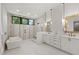 Spa-like bathroom with a standalone tub, large windows, and a double vanity with gold accents at 5208 Knollwood Rd, Raleigh, NC 27609