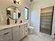 Modern bathroom with sleek vanity, elegant mirror, and a separate doorway to the closet at 5208 Knollwood Rd, Raleigh, NC 27609