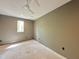 Bright bedroom with a modern ceiling fan and a large window offering serene outdoor views at 5208 Knollwood Rd, Raleigh, NC 27609