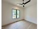 Minimalist bedroom with natural light, a ceiling fan, and contemporary finishes at 5208 Knollwood Rd, Raleigh, NC 27609