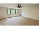 Bright bedroom with a modern ceiling fan and a large window offering views of the outdoors at 5208 Knollwood Rd, Raleigh, NC 27609