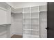 Spacious walk-in closet features built-in shelving and racks for storing clothes and accessories at 5208 Knollwood Rd, Raleigh, NC 27609