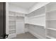 Walk-in closet with built-in shelving and clothing racks for optimal storage at 5208 Knollwood Rd, Raleigh, NC 27609