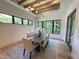 Elegant dining room with large windows, a modern chandelier, and a stylish area rug at 5208 Knollwood Rd, Raleigh, NC 27609