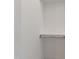 An empty, simple closet with a shelf and rack, ready for customization or storage at 5208 Knollwood Rd, Raleigh, NC 27609
