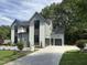 Lovely house with a concrete driveway and two-car garage at 5208 Knollwood Rd, Raleigh, NC 27609