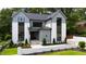 Home exterior with a combination of gray siding, white accents, and manicured lawn at 5208 Knollwood Rd, Raleigh, NC 27609