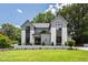 Beautiful two-story home featuring modern design elements and lush green lawn at 5208 Knollwood Rd, Raleigh, NC 27609