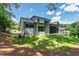 Back exterior view of home with green lawn, screened porch, and multi-pane windows at 5208 Knollwood Rd, Raleigh, NC 27609