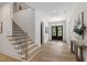 Bright and airy foyer with wood floors and staircase leading to the second level at 5208 Knollwood Rd, Raleigh, NC 27609