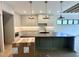 Modern kitchen featuring an island, stylish pendant lighting, and pristine marble countertops at 5208 Knollwood Rd, Raleigh, NC 27609