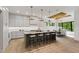 Open kitchen with a spacious island, sleek cabinets, and an adjacent dining area at 5208 Knollwood Rd, Raleigh, NC 27609