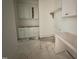 Bright laundry room featuring white cabinets and potential for efficient organization, awaiting finishing touches at 5208 Knollwood Rd, Raleigh, NC 27609