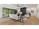Cozy living room boasts natural light, a black accent fireplace, and elegant hardwood flooring at 5208 Knollwood Rd, Raleigh, NC 27609