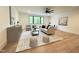 Bright living room boasts large window, modern furniture and decor, with wood flooring at 5208 Knollwood Rd, Raleigh, NC 27609