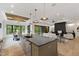 Spacious living area with black countertops, a fireplace, and floor-to-ceiling windows offering scenic views at 5208 Knollwood Rd, Raleigh, NC 27609