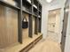 Convenient mudroom featuring built-in cubbies, hooks, and bench seating for organized storage and easy access at 5208 Knollwood Rd, Raleigh, NC 27609