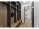 Mudroom with custom built-in shelving and wood bench, offering storage at 5208 Knollwood Rd, Raleigh, NC 27609