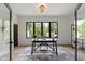 Bright office with a large window offering a view of lush green trees at 5208 Knollwood Rd, Raleigh, NC 27609