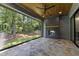 Covered patio featuring a stone floor, fireplace, and backyard view at 5208 Knollwood Rd, Raleigh, NC 27609