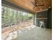 Covered outdoor living space with stone floors, a wood ceiling, and a cozy fireplace, perfect for entertaining at 5208 Knollwood Rd, Raleigh, NC 27609