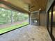 A covered patio with a stone floor, outdoor fireplace, wood-paneled ceiling, and a view of the landscaped yard at 5208 Knollwood Rd, Raleigh, NC 27609
