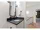 Elegant powder room with modern fixtures, a marble countertop, and stylish lighting at 5208 Knollwood Rd, Raleigh, NC 27609