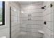Tiled walk-in shower featuring glass surround, a rainfall shower head, and corner shelf at 5208 Knollwood Rd, Raleigh, NC 27609