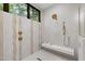Luxurious shower with modern fixtures, a built-in bench, and designer tile-work at 5208 Knollwood Rd, Raleigh, NC 27609