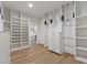 Spacious walk-in closet with custom shelving, wooden floors and hanging racks for clothing storage at 5208 Knollwood Rd, Raleigh, NC 27609