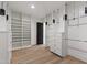 Bright, organized walk-in closet featuring custom shelving and wooden floors for ample storage space at 5208 Knollwood Rd, Raleigh, NC 27609