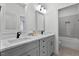 Bathroom featuring dual sinks, gray cabinets, and a tiled floor at 55 Harvest View Way, Franklinton, NC 27525