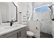 Modern bathroom with marble tile, black fixtures, and a sleek vanity with a stylish mirror at 55 Harvest View Way, Franklinton, NC 27525