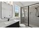 Bathroom featuring glass shower, dark hardware, and quartz countertop sink at 55 Harvest View Way, Franklinton, NC 27525